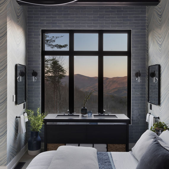 Chip Wades residential renovation, Pinhoti Peak, master bedroom with black quartz vanity countertop, gray glossy wall tile, and large windows with mountain view.