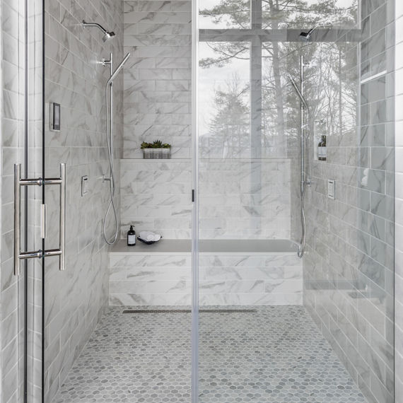 Chip Wades residential renovation, Pinhoti Peak, master bathroom shower with white and gray marble look tile and white quartz shower bench and shelving.
