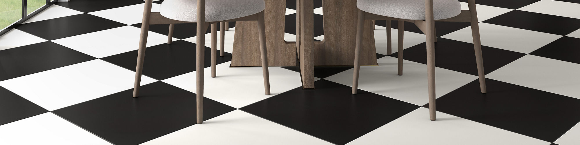 Dining room with black and white square concrete look tile in checkered pattern, wood cabinets, and white dining table with white chairs.