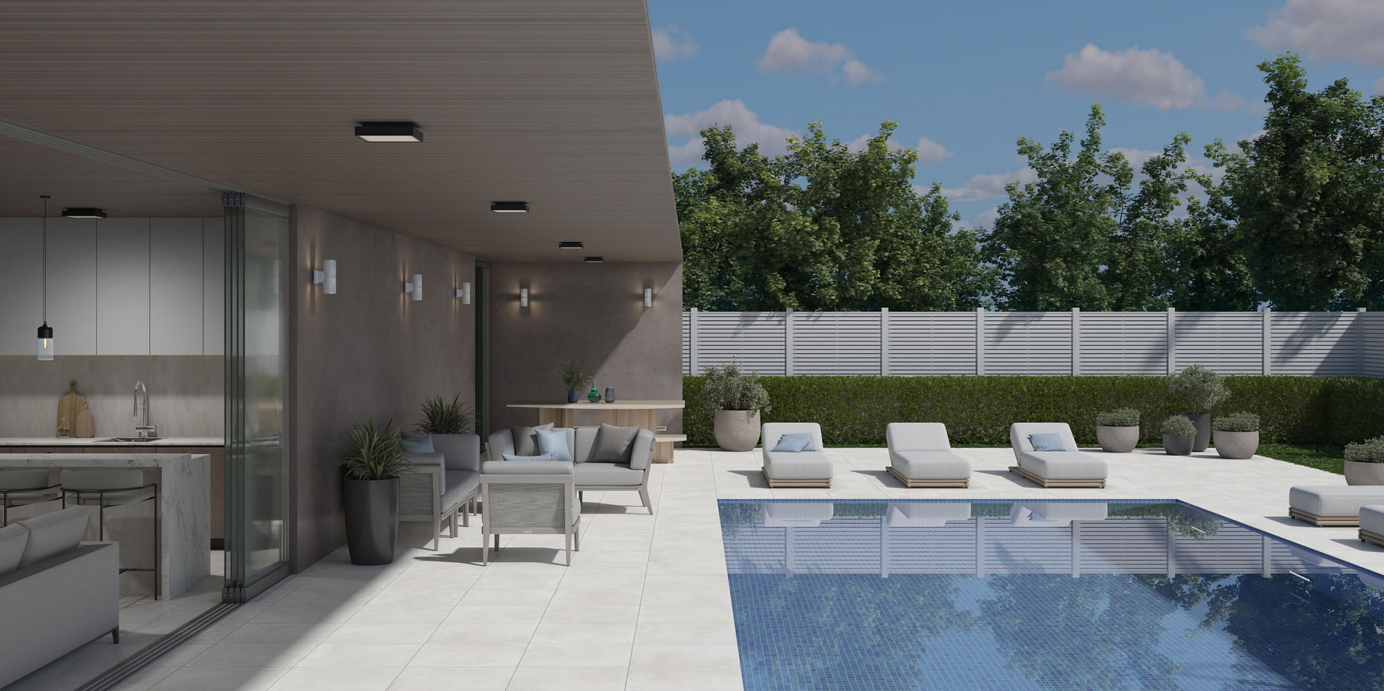 Backyard with white stone look pavers, white pool chairs, and a large pool.