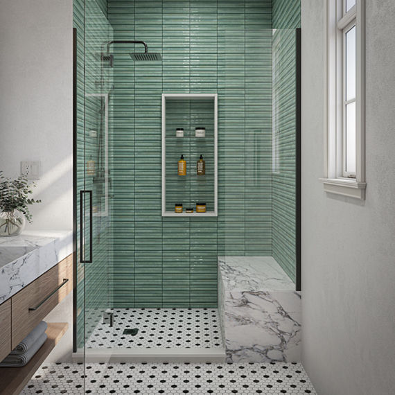 Bathroom with light blue fluted rectangle mosaic on shower walls, white marble look countertop and shower bench, white and black hexagon mosaic on floor, and white walls.