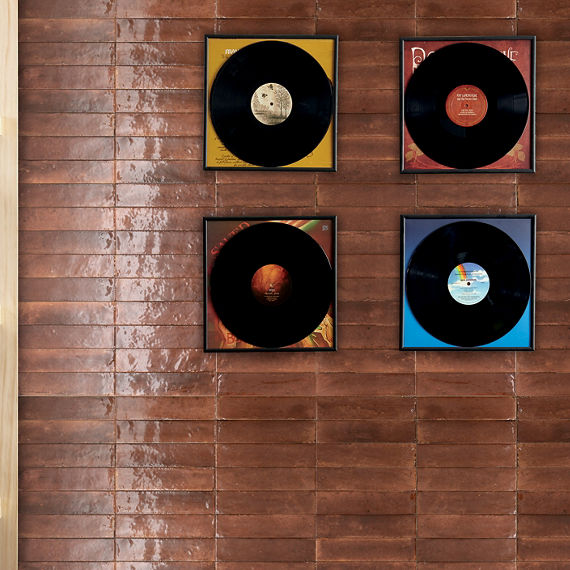 Room with records on wall, light wood shelves, and an amber rectangle wall tile.