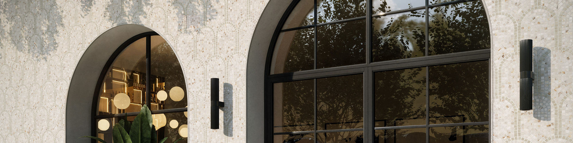 A contemporary storefront features a large glass door beside an arched display window. Inside, warm pendant lights and lush indoor plants create an inviting atmosphere. The exterior wall is clad in patterned tiles with climbing greenery cascading fro