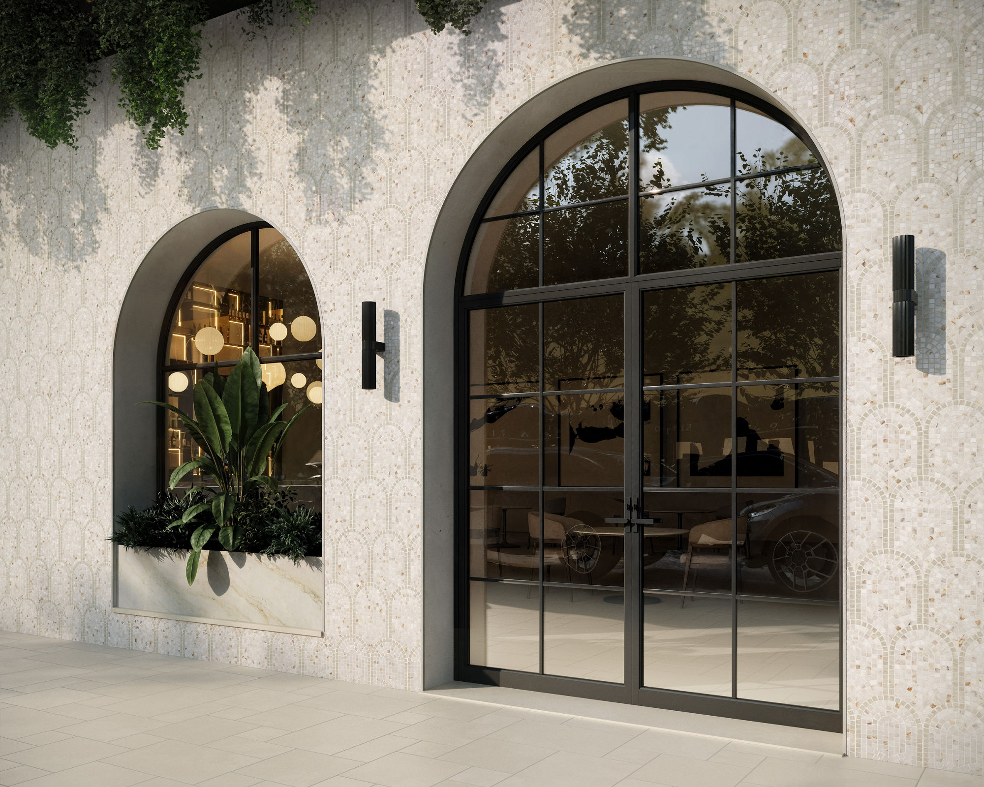 A contemporary storefront features a large glass door beside an arched display window. Inside, warm pendant lights and lush indoor plants create an inviting atmosphere. The exterior wall is clad in patterned tiles with climbing greenery cascading fro