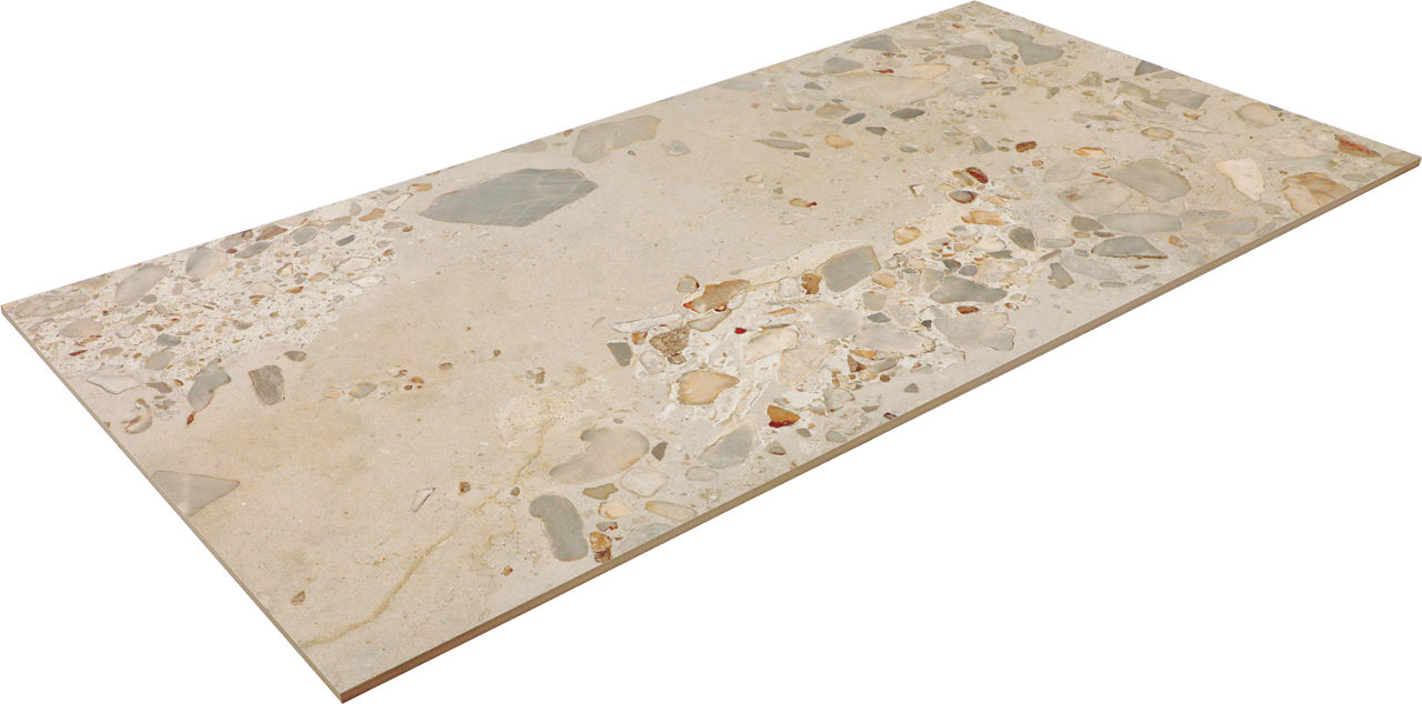Rectangular beige terrazzo tile with scattered stone chips is shown isolated on a white background. The tile surface features a mix of light and medium-toned aggregate pieces, creating a natural decorative pattern. Subtle variations in color and text