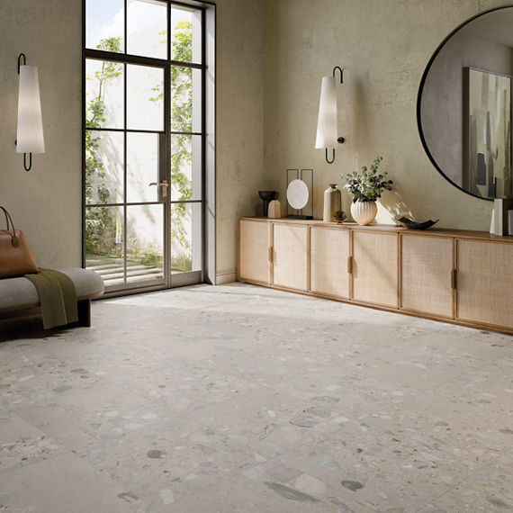 Bedroom with long wood cabinet and a beige stone look floor tile.