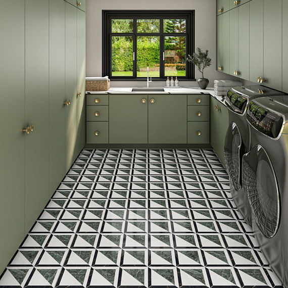 Laundry room with green cabinets, washer and dryer, and an encaustic marble look tile on floor.