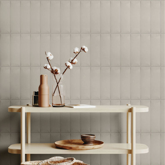 White shelf with wooden plate and bowl, orchid in clear jar on top shelf, and beige rectangle tile with half moon design on back wall.