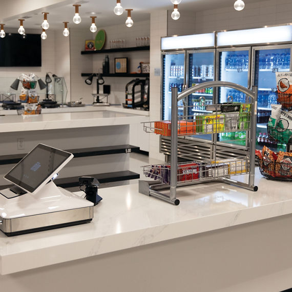 FC Cincinnati TQL Stadium concession stands with marble look white quartz countertops and refrigerated display cases with beverages.