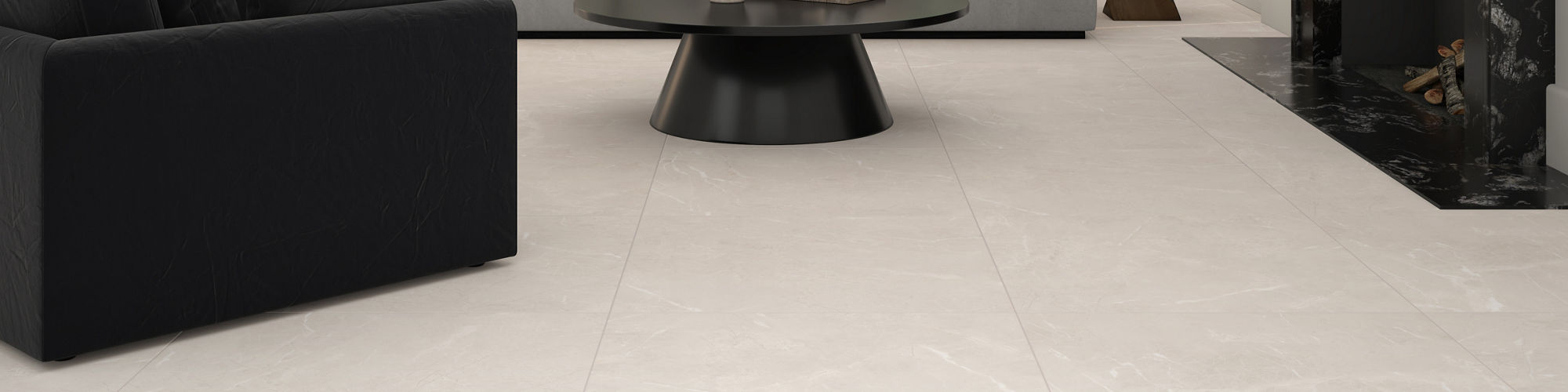 Living room with white marble look tile on floor, gray couch, white walls, and black coffee table.