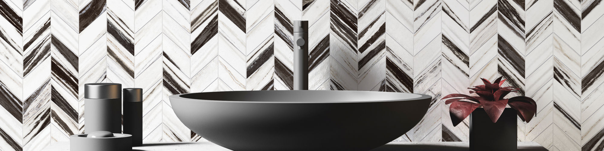 Bathroom with white marble look herringbone mosaic on backwall, round gray sink, gray cabinet, and white countertop.