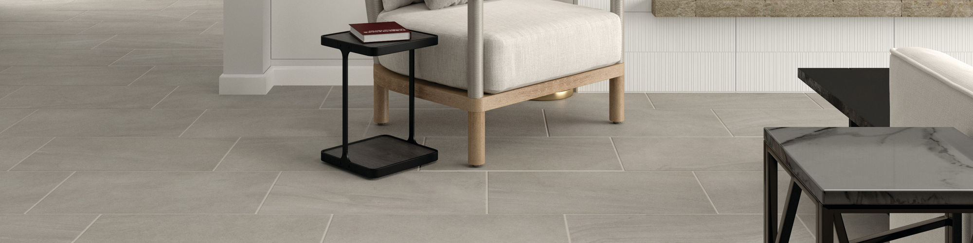 Fireplace with white walls, white furniture and gray stone look flooring.