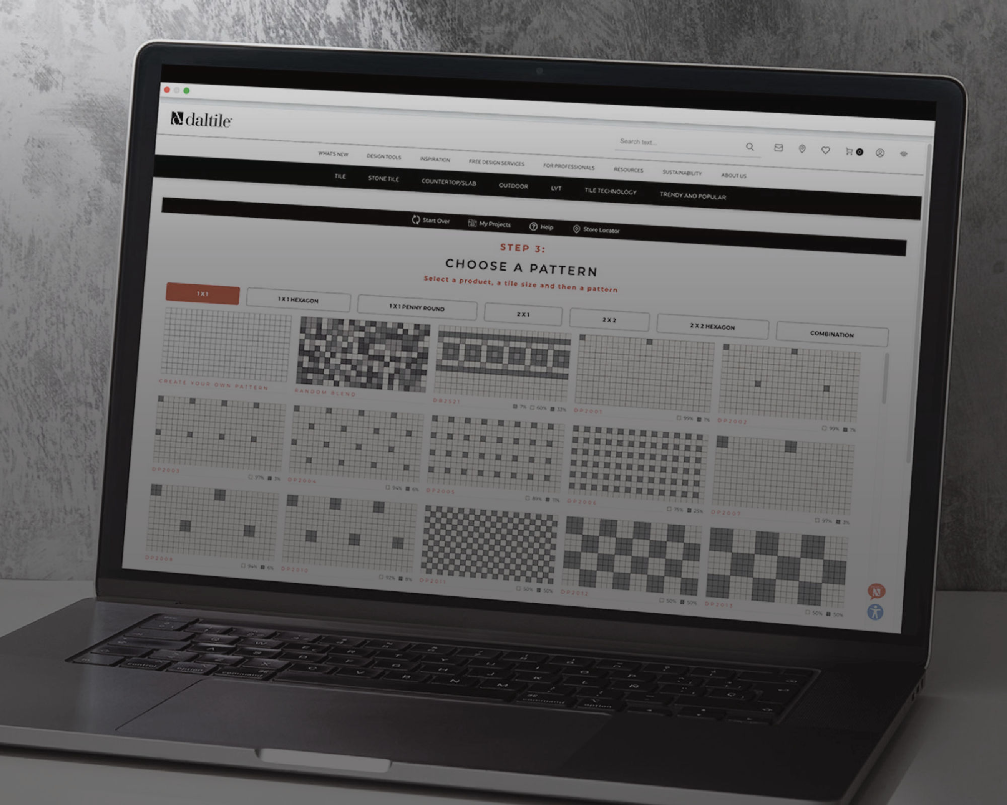 A laptop computer sits on a surface, displaying a web-based interface for choosing a pattern. The screen shows a grid of small black-and-white pattern thumbnails arranged in rows and columns. The surrounding environment is minimal, with a textured gr