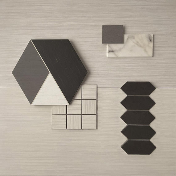 This flatlay contains a fabric look tile accented by a marble accent tile, picket mosaic, fabric look mosaic, concrete accent tile, and an encaustic hexagon tile.