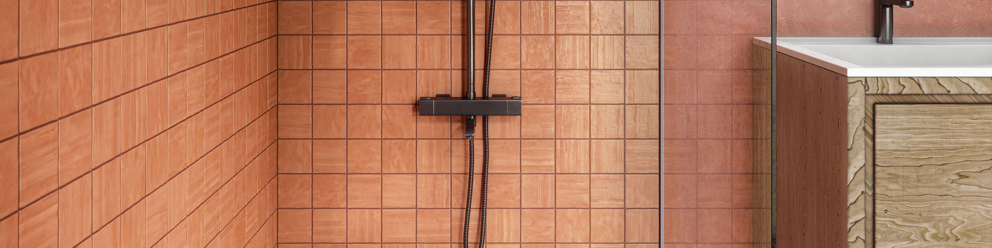 Contemporary bathroom featuring a walk-in shower with terracotta square tiles and a black rainfall shower fixture. A glass partition separates the shower from a light wood vanity with a stone countertop and built-in sink. On the left, a recessed shel