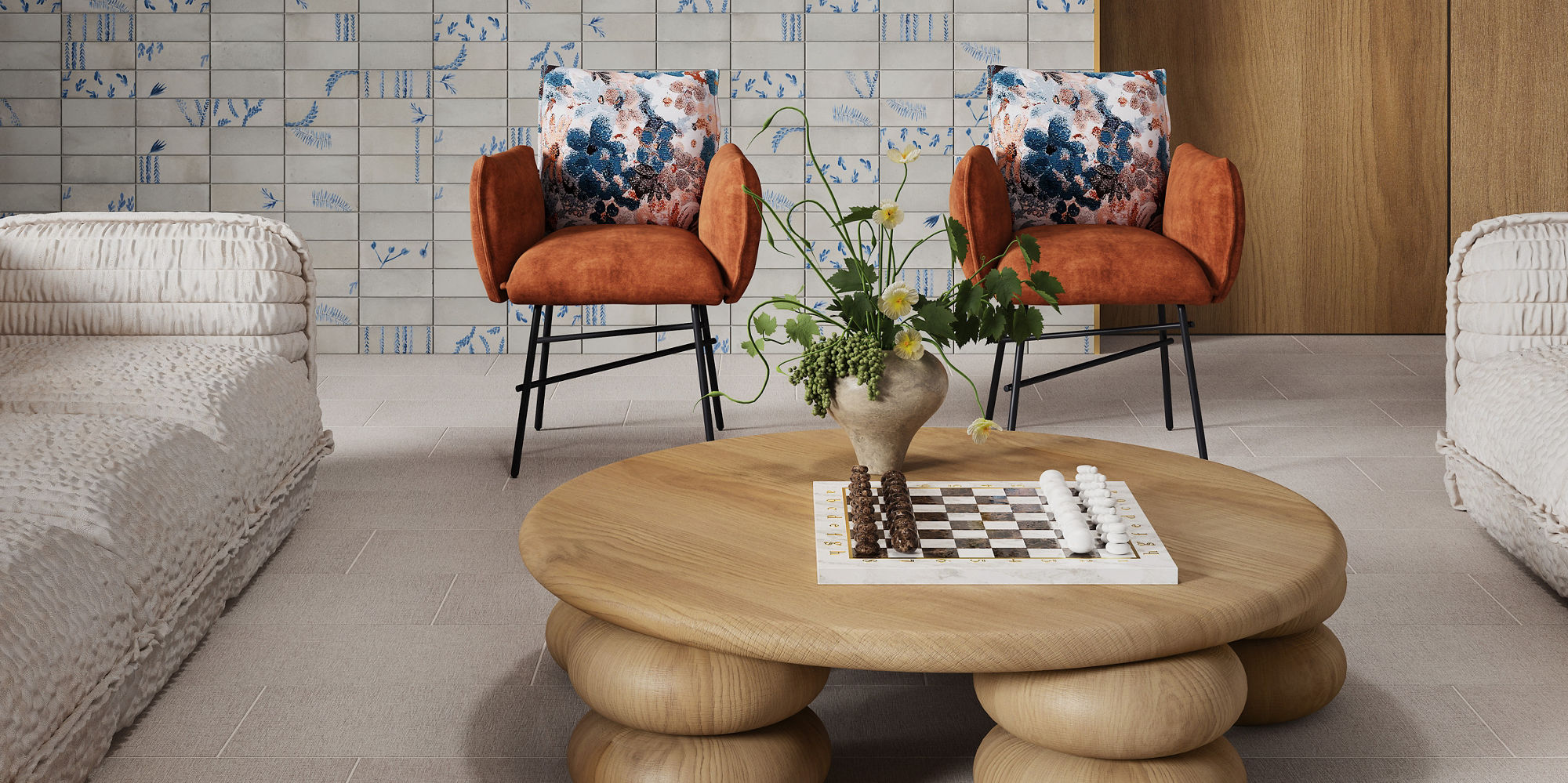 Waiting area with white and blue encaustic rectangle wall tile, wood side wall, beige fabric look rectangle floor tile, two white couches, wooden center table, and two orange chairs.