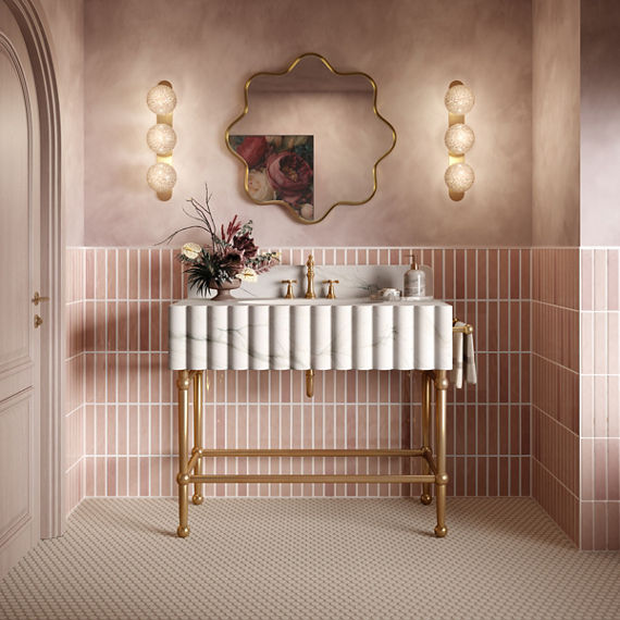 Bathroom with pink rectangle tile on bottom half of wall in vertical pattern, pink walls on top half, beige penny round mosaic on floor, and white marble look sink.