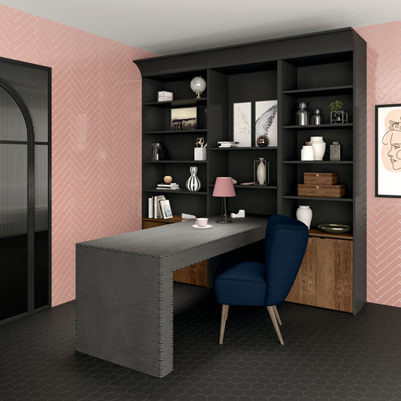 Home office with pink subway tile in herringbone pattern on back wall, dark gray cabinets, dark gray desk, and blue chair.