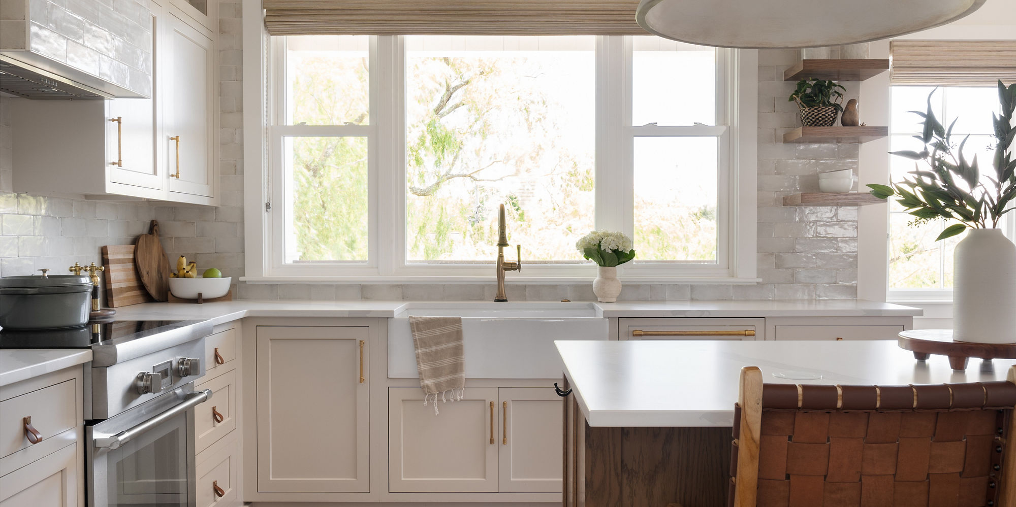 Kitchen with white cabinets, white subway tile on backsplash, and white countertop.