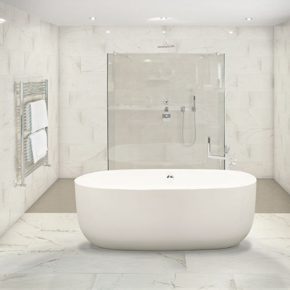 Bathroom with white marble look rectangle tile on floor and back wall, white tub, and glass shower in back.