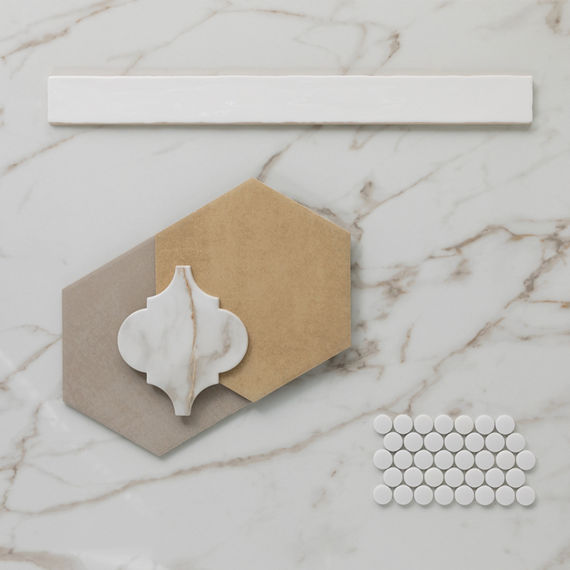 This flatlay contains a marble look tile accented by concrete look hexagon tiles, marble arabesque tile, penny round mosaic tiles, and a solid white trim.