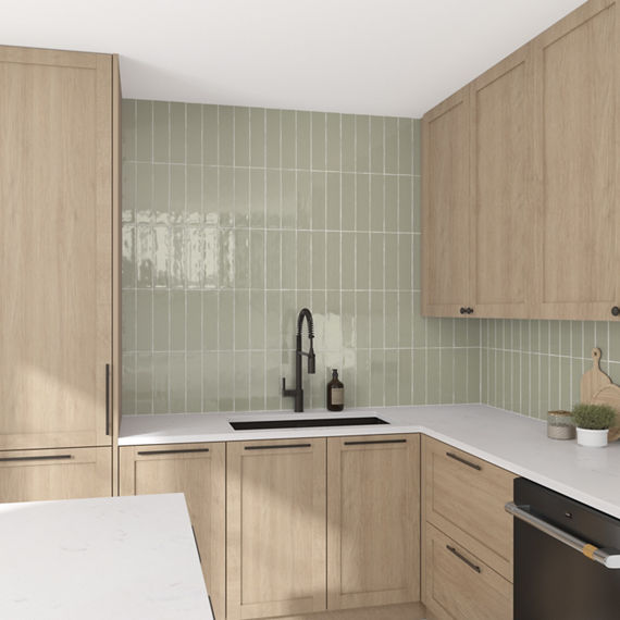 Kitchen with light green rectangle tile on backsplash in vertical pattern, light wood cabinets, and white countertop.