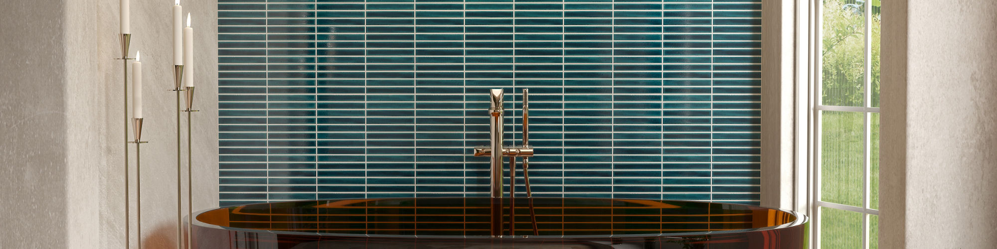 Bathroom with red bathtub, orange hexagon floor tile, white walls, and blue fluted tile on back wall.