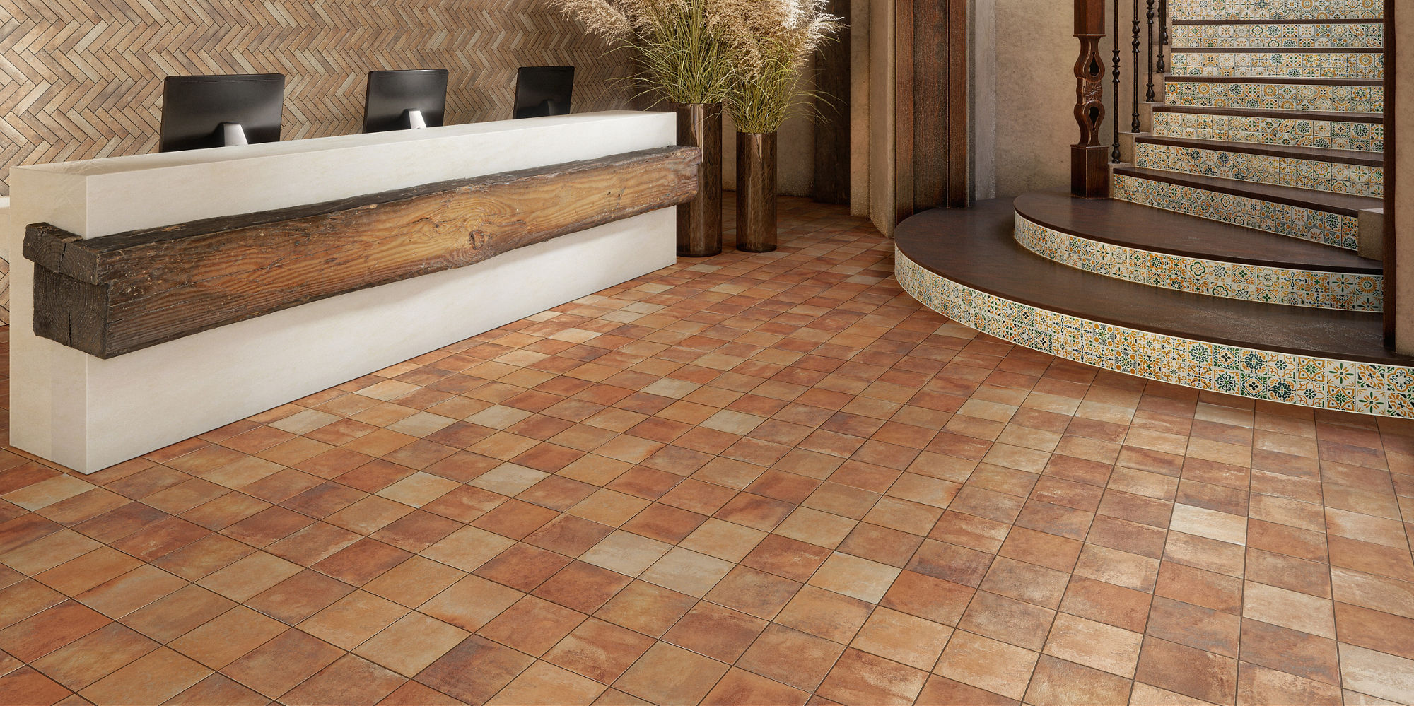 Welcome area with orange cotto look square floor tile, white and green encaustic square tile on stairs, and wood accents.