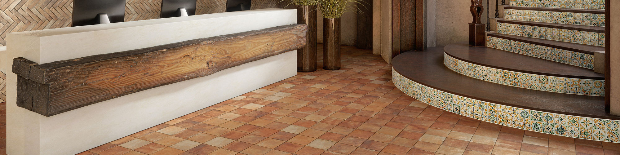 Welcome area with orange cotto look square floor tile, white and green encaustic square tile on stairs, and wood accents.