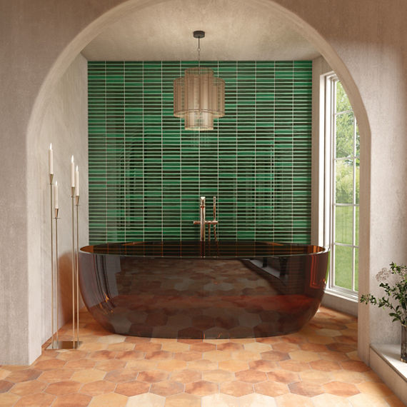 Bathroom with red bathtub, orange hexagon floor tile, white walls, and greenfluted tile on back wall.
