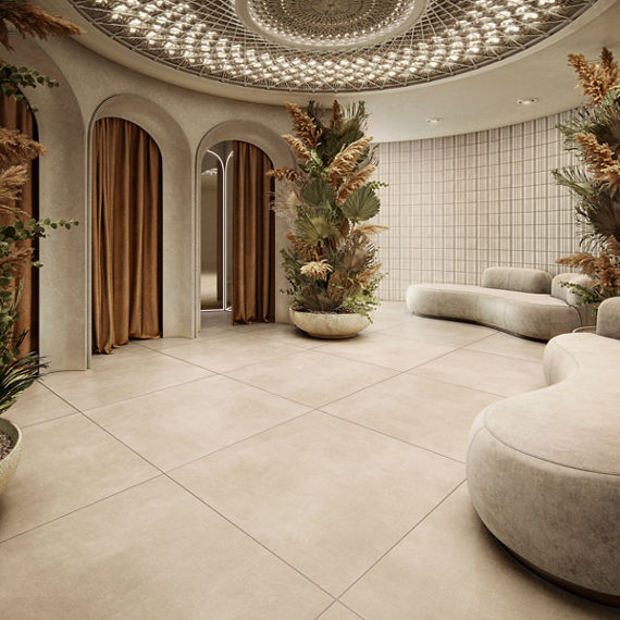 Dressing room waiting area with off white large format square concrete look floor tile, white couches, three dressing rooms with orange curtains, and a large vase with greenery.