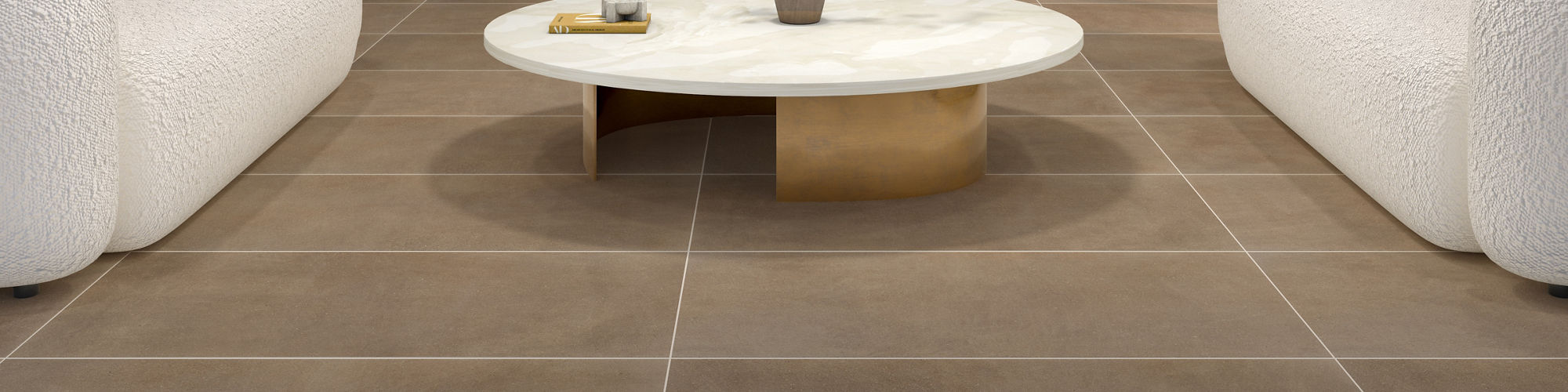 Living room with brown rectangle large format concrete look floor tile, two white couches, wood accents, and a fireplace in the middle.