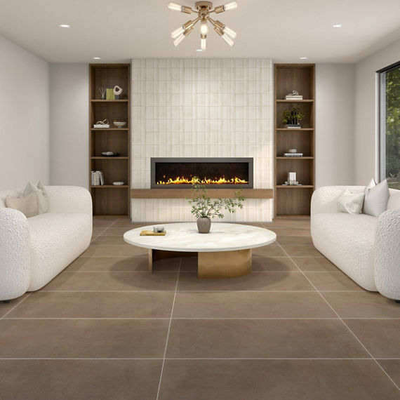 Living room with gray square large format concrete look floor tile, two white couches, wood accents, and a fireplace in the middle.