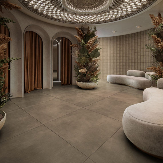 Dressing room waiting area with gray large format square concrete look floor tile, white couches, three dressing rooms with orange curtains, and a large vase with greenery.