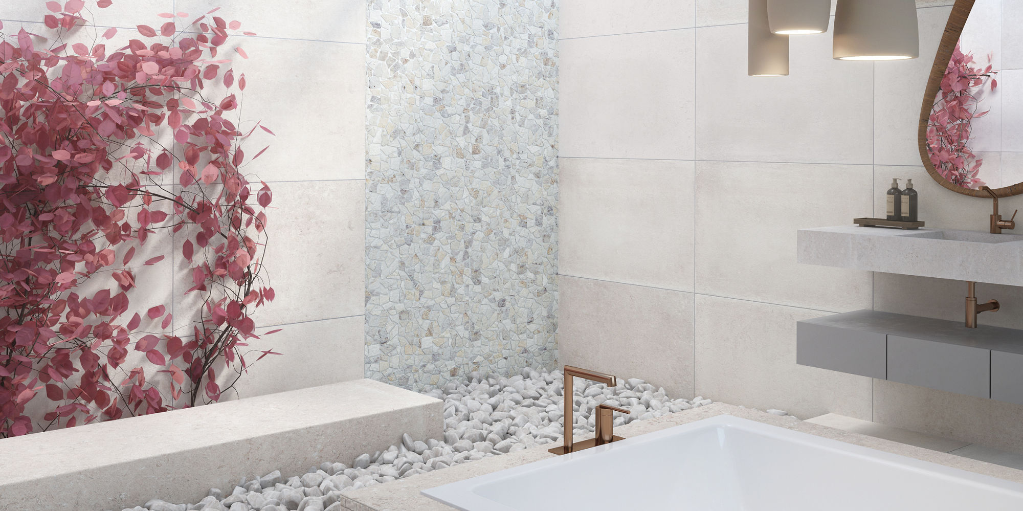 Bathroom with white concrete look tile on floors and walls, large tub in middle, pebble mosaic on back wall, pink flowers on back wall, and gold accents.