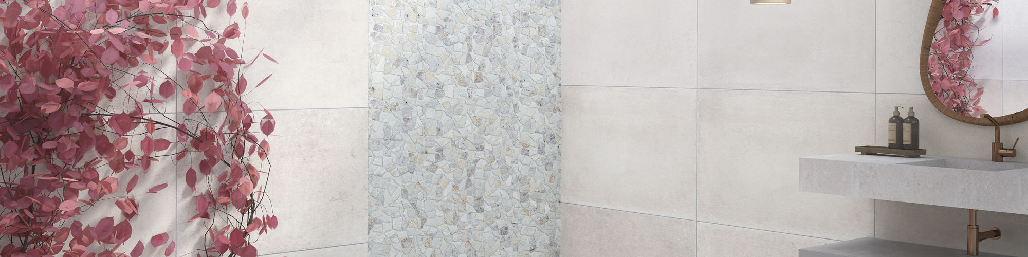 Bathroom with white concrete look tile on floors and walls, large tub in middle, pebble mosaic on back wall, pink flowers on back wall, and gold accents.