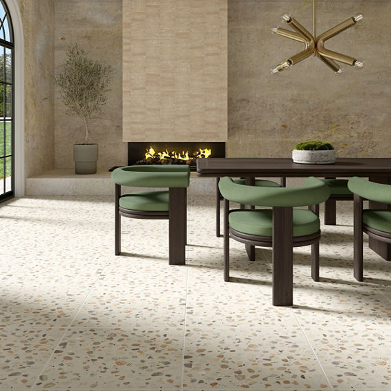 Dining room with white terrazzo look square floor tile, green dining chairs, dark wooden dining table, and a fireplace in the back.
