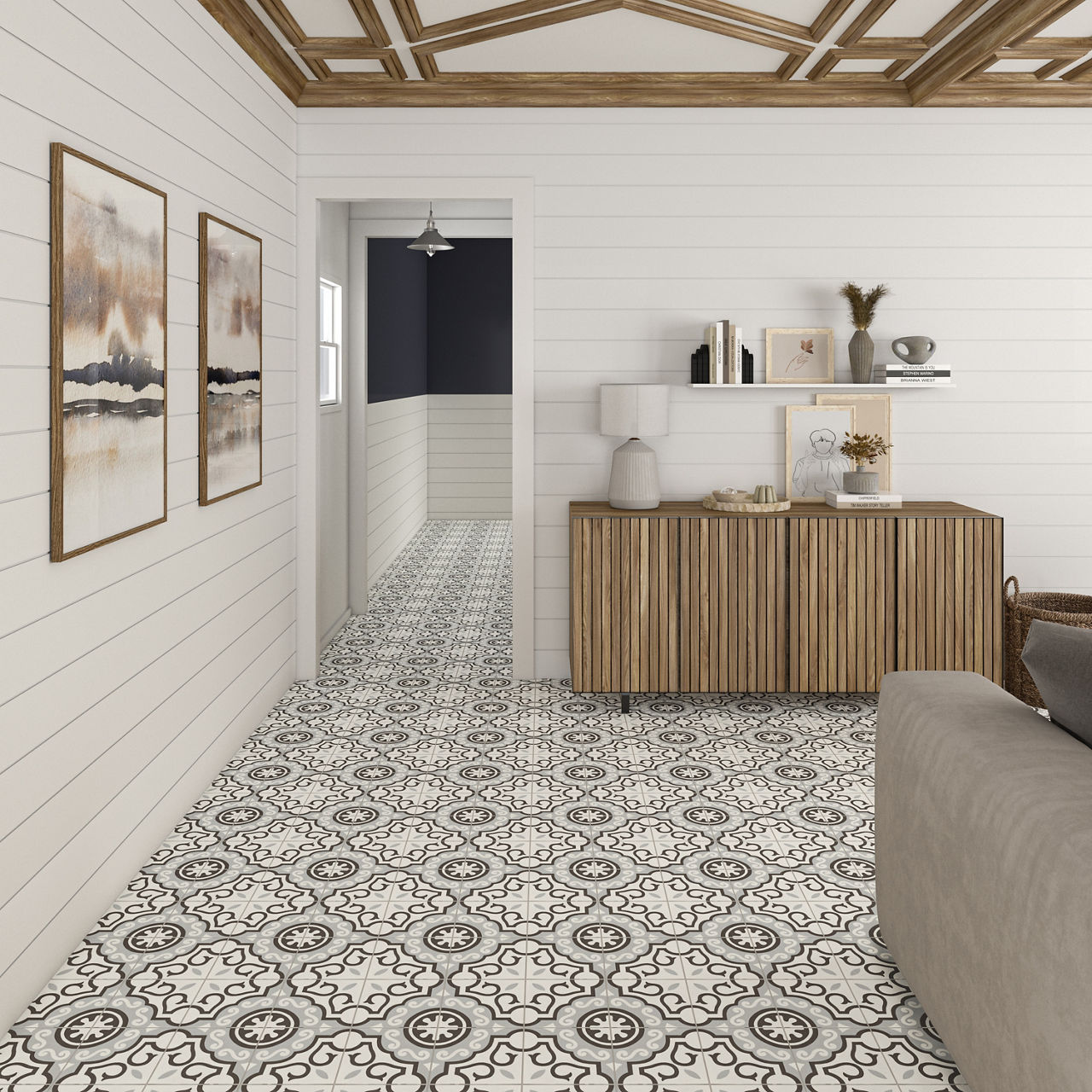 Room with white encaustic concrete look tile on floor, gray couch, white paneled walls, and wood accents.
