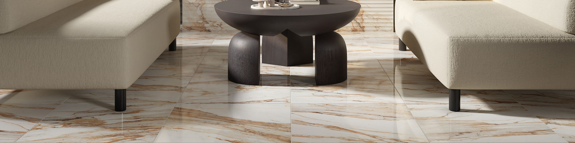 A contemporary living room features glossy marble-look floor tiles with warm brown veining. Two minimalist cream sofas face each other around a low round coffee table in front of a sleek fireplace. Dark paneled walls contrast with the light stone sur