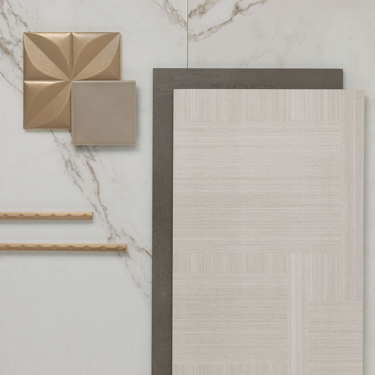 This flatlay contains a marble look tile accented by fabric look tile, metal three dimensional accent tile, concrete look accent tile, and metal jollies.