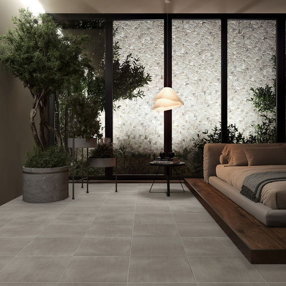Bedroom with white stone look mosaic tile on back wall, gray stone look square floor tile, and large pot with tree in corner.