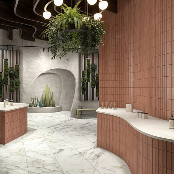 Spa with orange subway tile in vertical pattern on walls and counters, white countertops, white marble look rectangle floor, and greenery on walls.