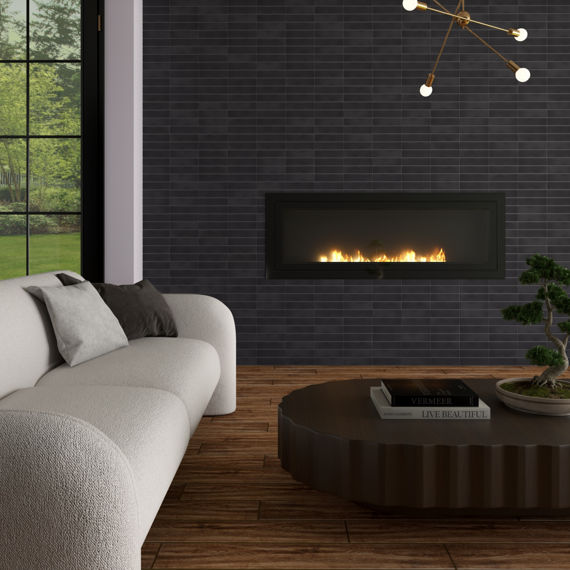 Living room with wood look plank tile, black rectangle tile on fireplace, white couch, and  black coffee table with bonsai tree.