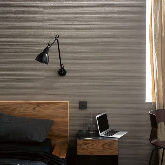 Bedroom with warm toned white fluted tile.