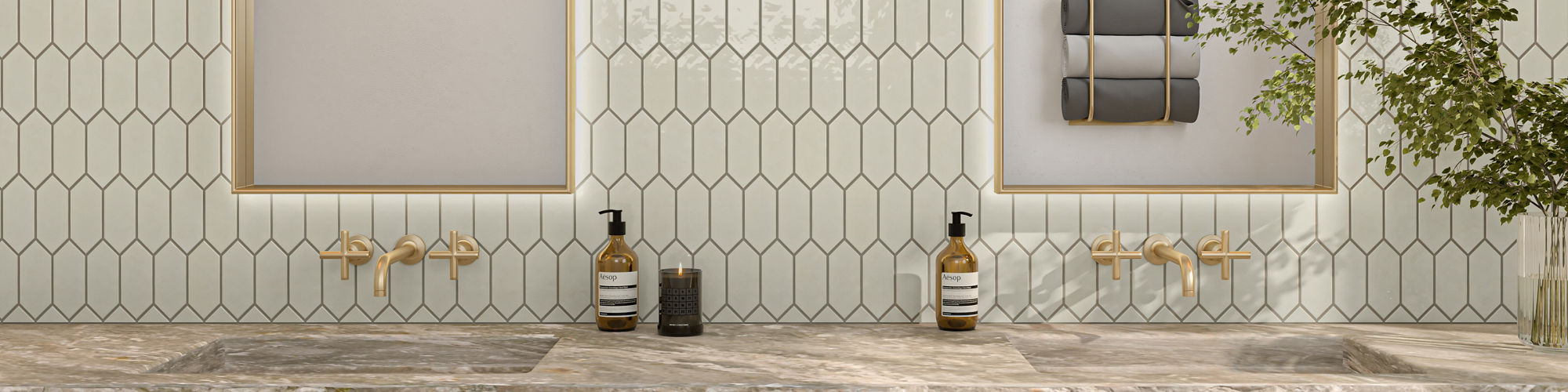 Bathroom with white picket mosaic on backsplash, taupe concrete look square floor tile, and gold accents.