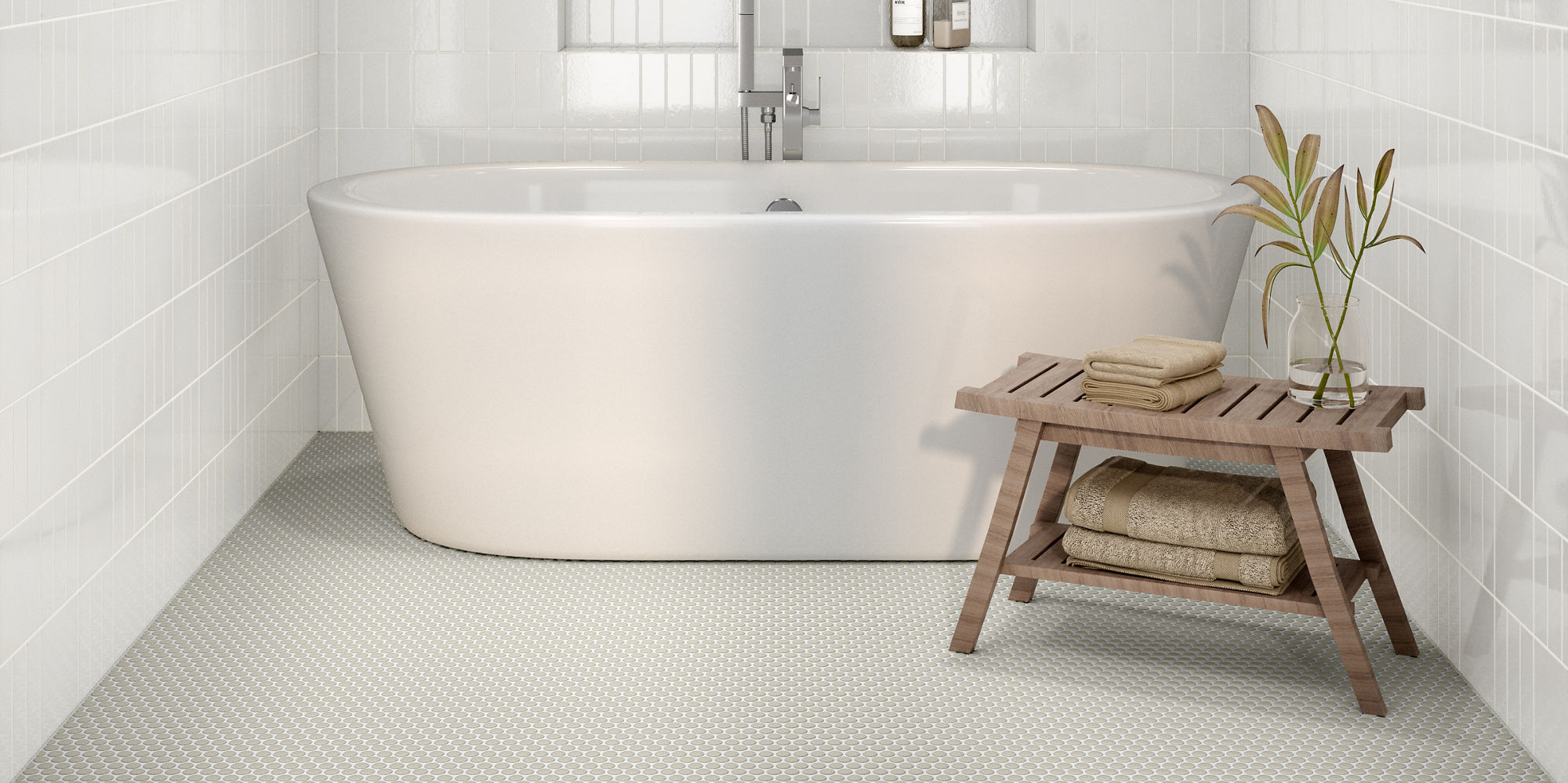 A sleek, contemporary bathroom features a white freestanding bathtub centered against glossy white tiled walls. 