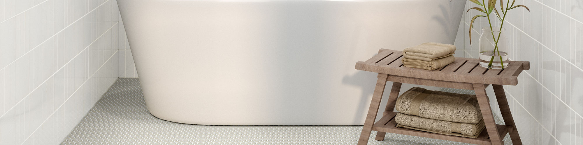 A sleek, contemporary bathroom features a white freestanding bathtub centered against glossy white tiled walls. 