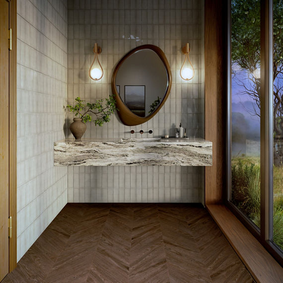 Bathroom with white fluted rectangle tile on walls, white granite counter, wood look tile in chevron pattern, and floor to ceiling window showing the outdoors.
