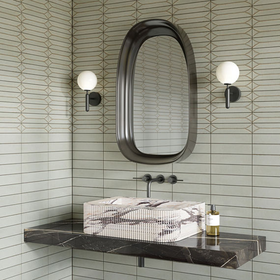 Bathroom with white marble sink, gray marble countertop, silver fixtures, and white rectangle subway tile on background.