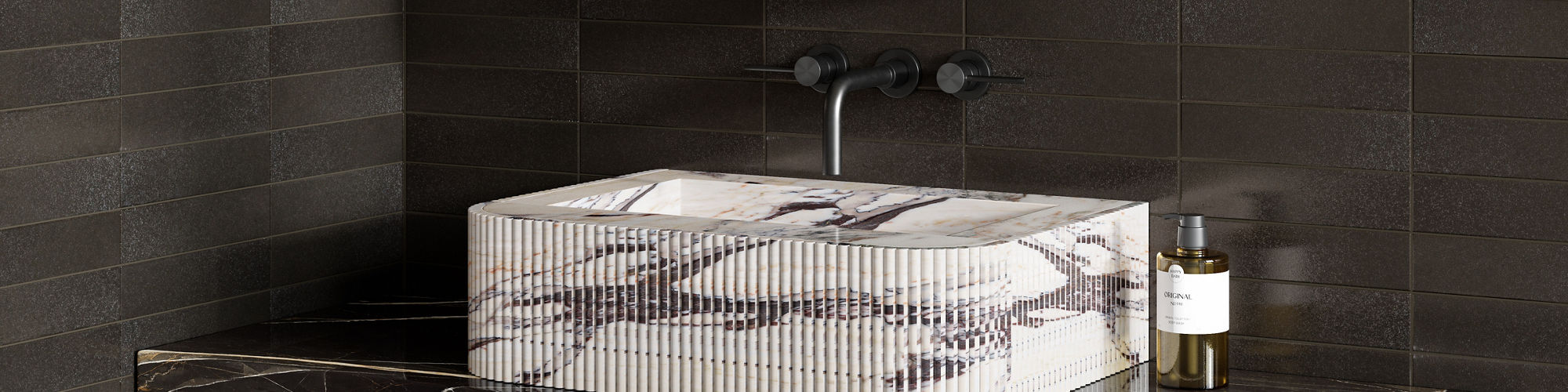 Bathroom with white marble sink, gray marble countertop, silver fixtures, and black rectangle subway tile on background.